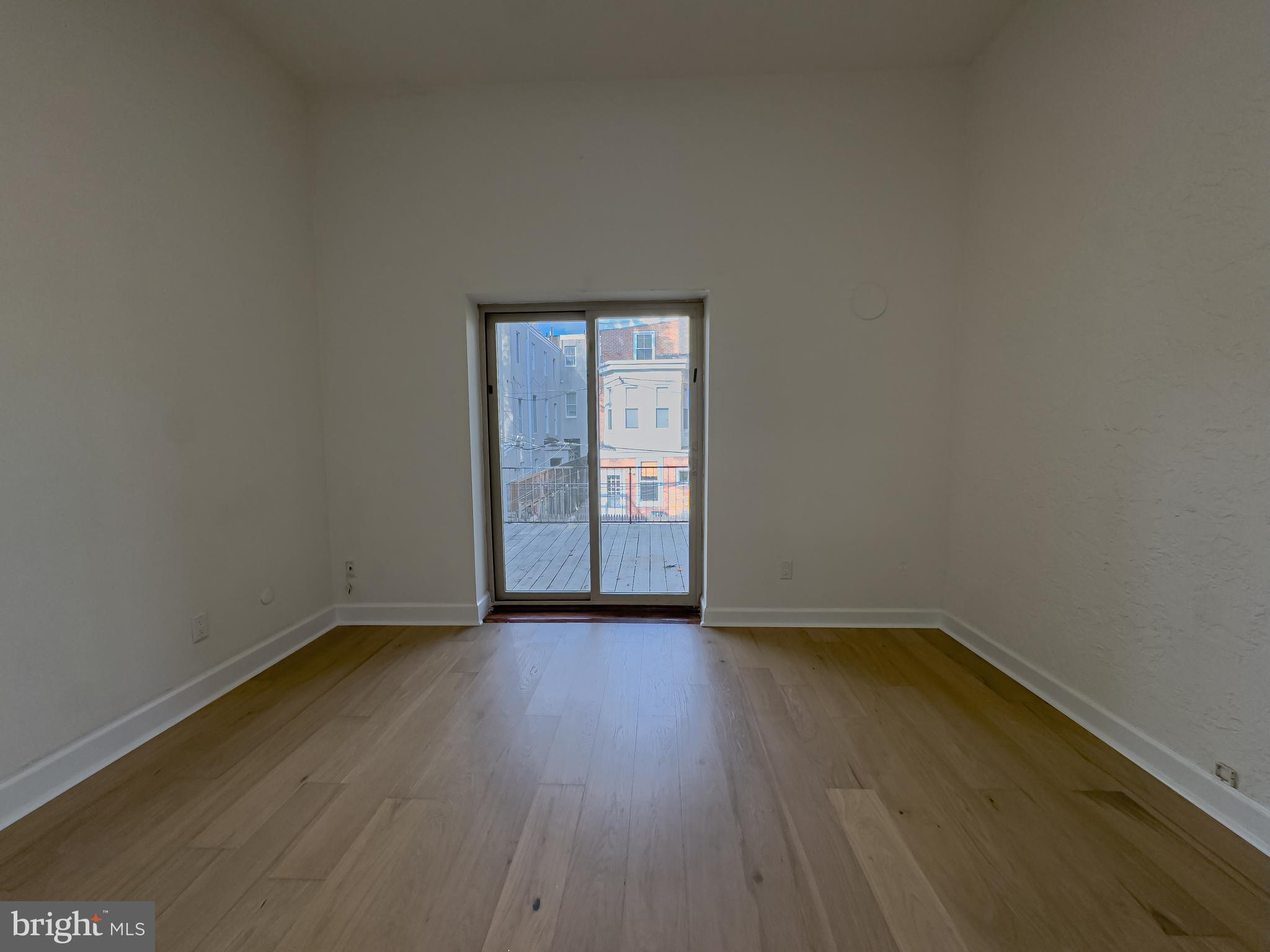 2007 Green Street, Unit 2R Philadelphia, PA 19130 - Photo 10 of 15 an empty room with wooden floor and windows