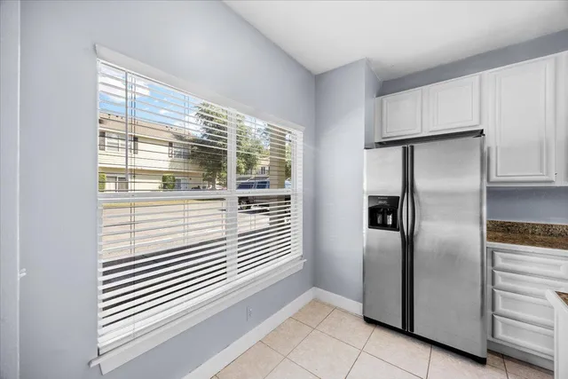 a kitchen with stainless steel appliances wooden floor and a window