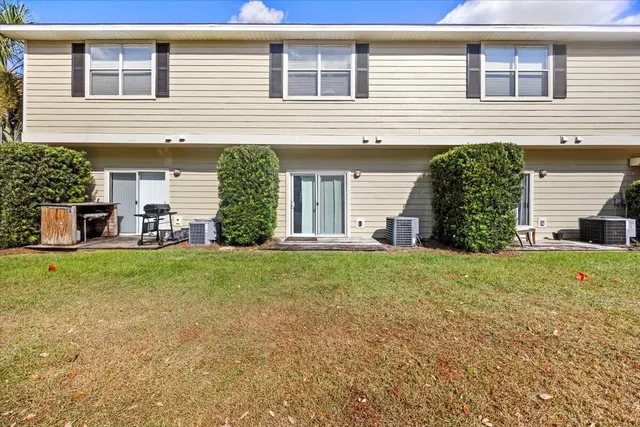 a view of a house with backyard and a garden