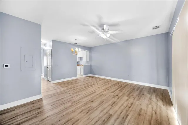wooden floor in an empty room with a window