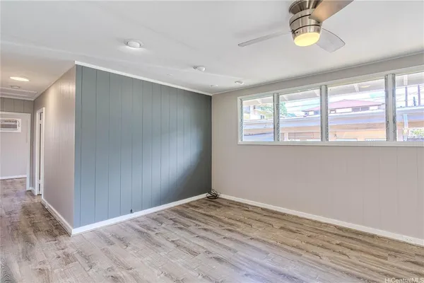 an empty room with windows and closet