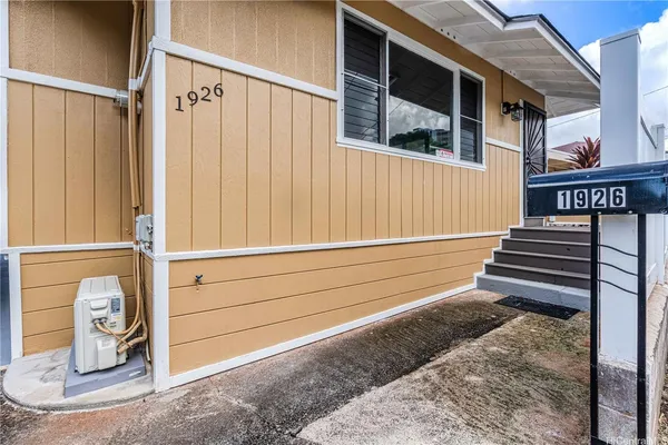 a view of a house with a door and wooden walls
