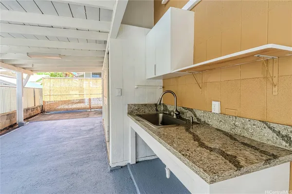 a kitchen with a sink and large window