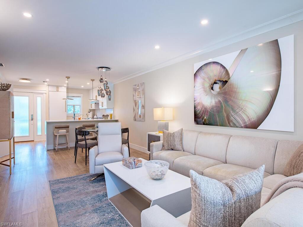 Living area with light wood-style floors, recessed lighting, and ornamental molding
