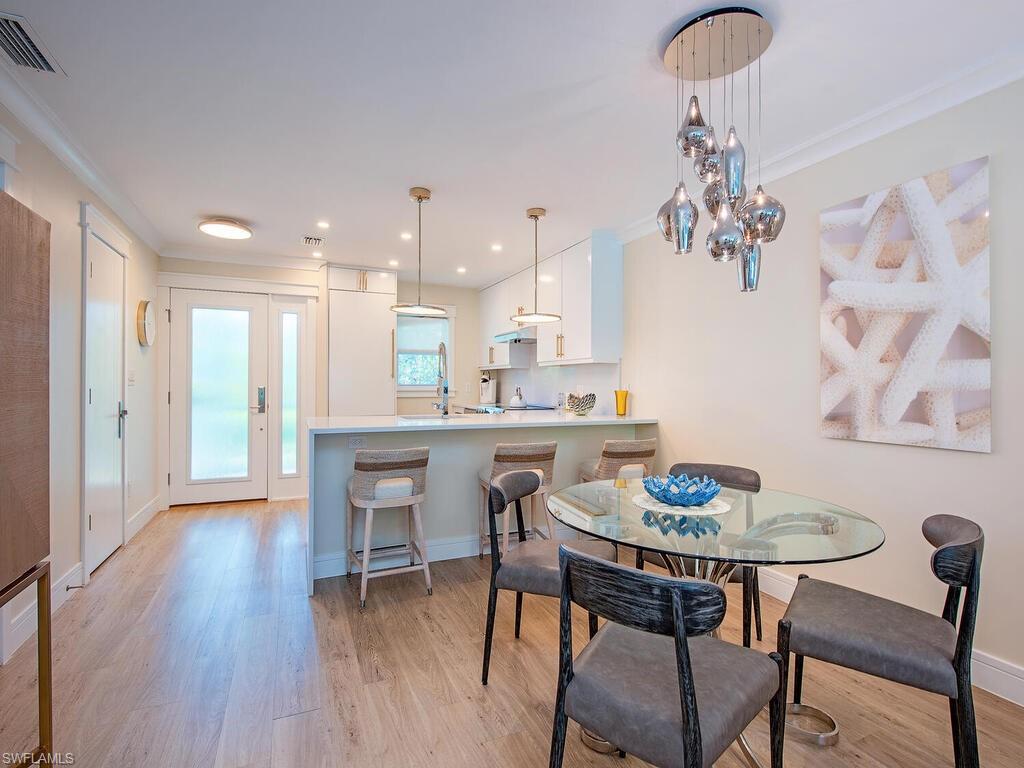 536 2nd Street South, Unit 536 Naples, FL 34102 - Photo 4 of 14 Dining area with light wood finished floors and ornamental molding