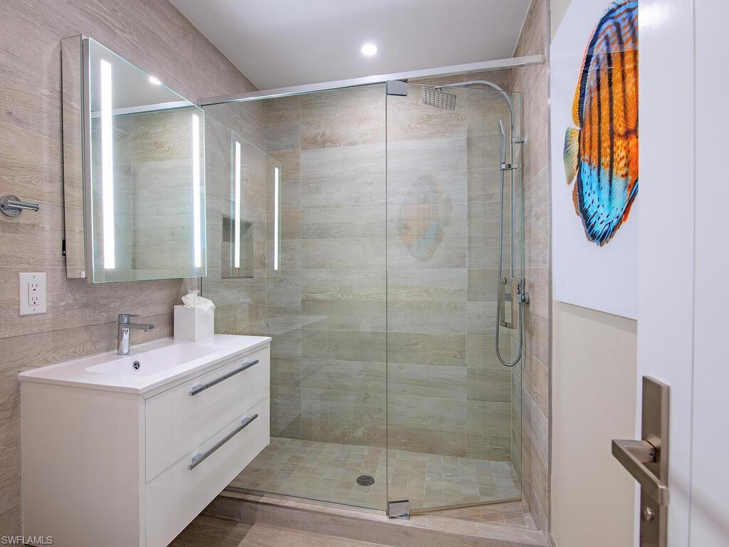 536 2nd Street South, Unit 536 Naples, FL 34102 - Photo 9 of 14 Full bath with vanity and a stall shower
