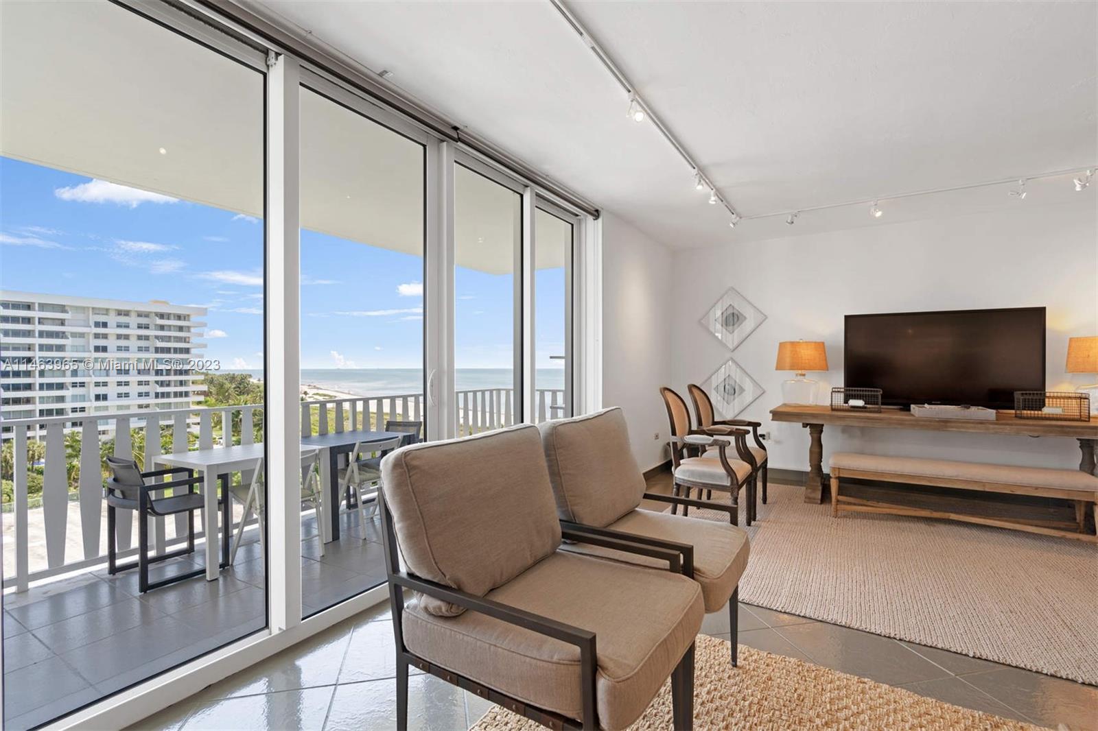 200 Ocean Ln Drive, Unit 703 Key Biscayne, FL 33149 - Photo 2 of 26 a living room with furniture and a flat screen tv