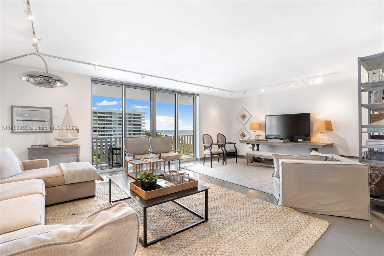 200 Ocean Ln Drive, Unit 703 Key Biscayne, FL 33149 - Photo 3 of 26 a living room with furniture a flat screen tv and a window