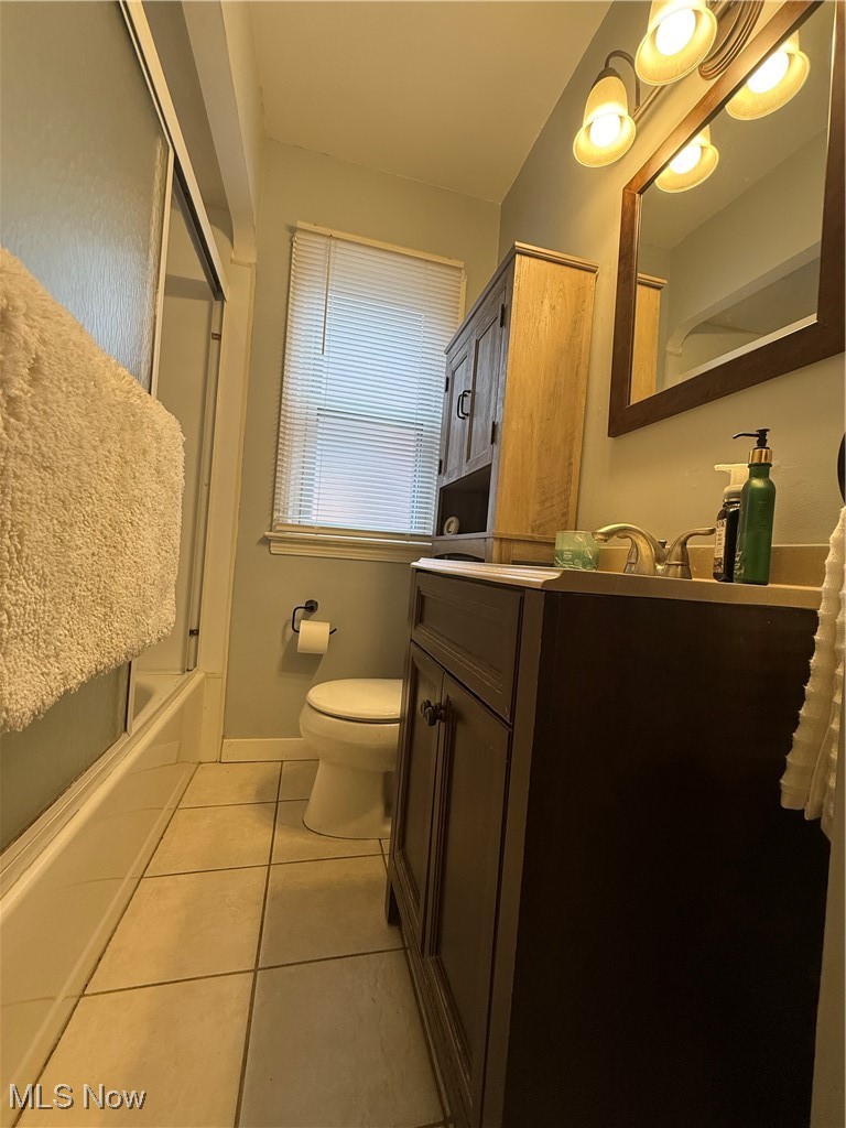7511 Jameson Road Parma, OH 44129 - Photo 18 of 27 Bathroom featuring tile patterned floors, vanity, toilet, and shower / washtub combination