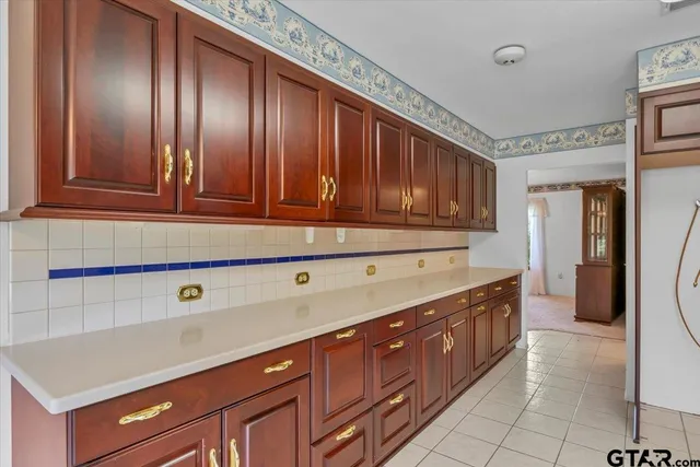 a bathroom with a granite countertop sink a mirror and a vanity