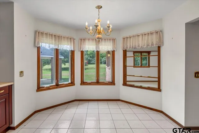 a view of an empty room with a ceiling fan