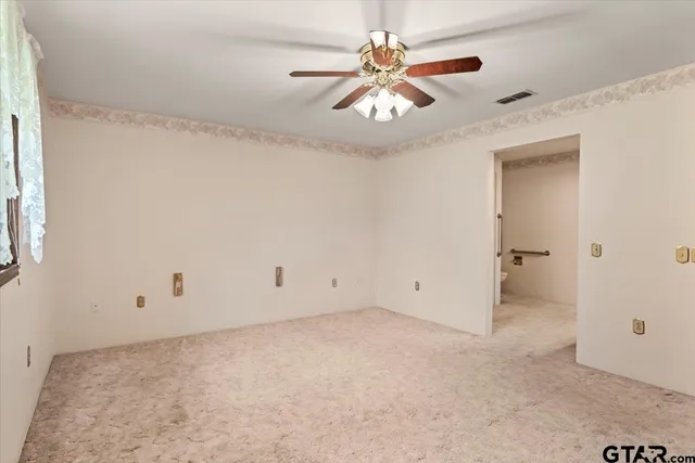 a view of a hallway with a chandelier fan and windows