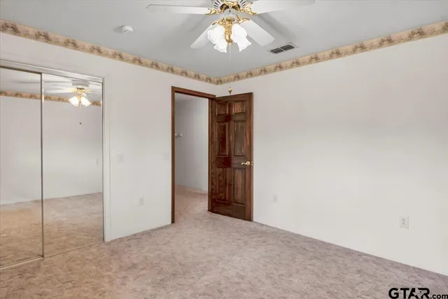 a white toilet sitting next to a white cabinet