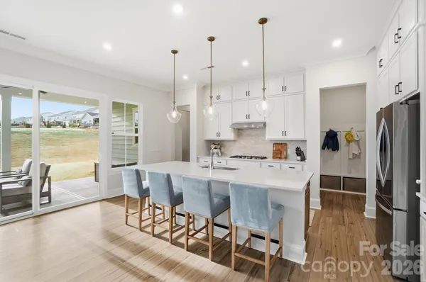 a large kitchen with lots of counter space and stainless steel appliances