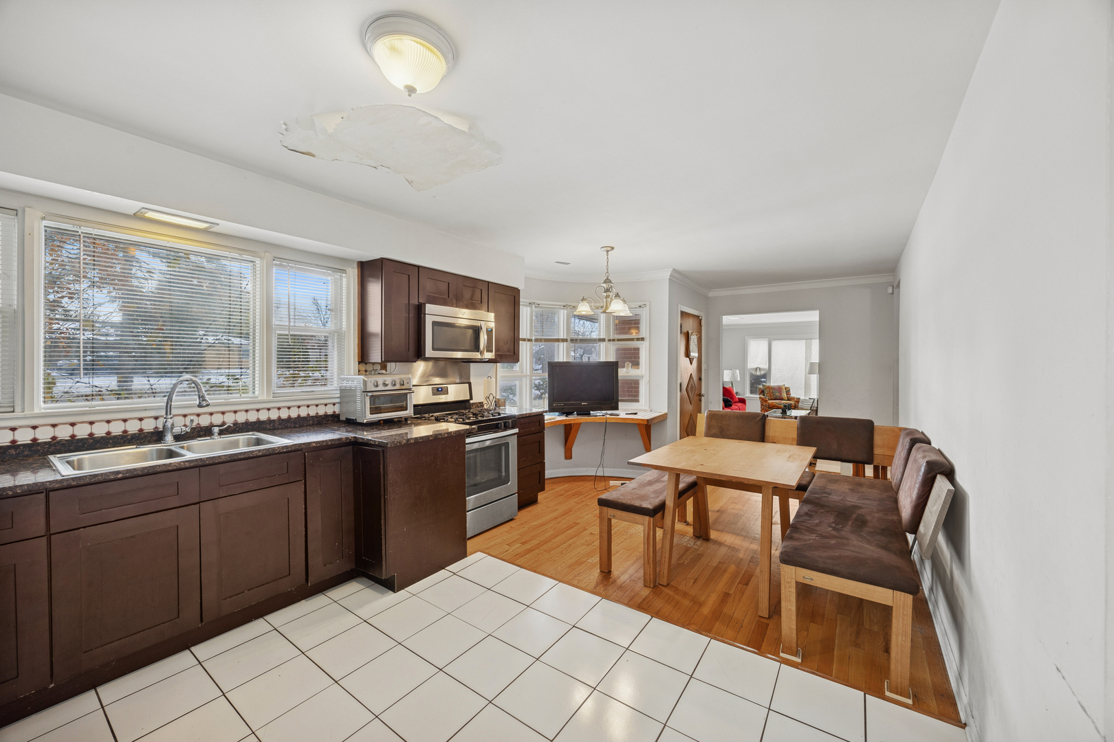 2929 Flossmoor Road Flossmoor, IL 60422 - Photo 15 of 20 a open kitchen with stainless steel appliances granite countertop a sink table and chairs