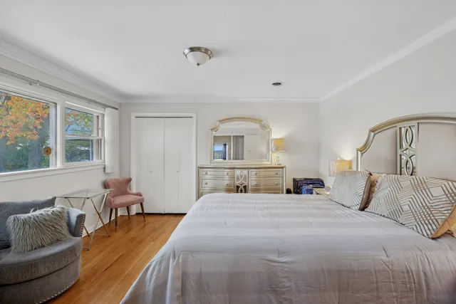 a bedroom with a large bed and a window