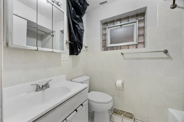 a bathroom with a sink a toilet and mirror