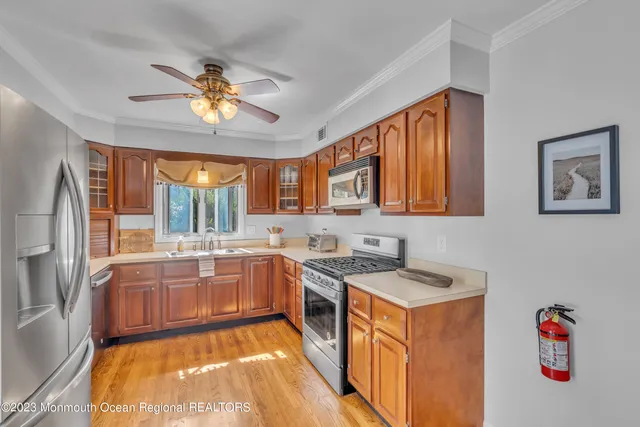a kitchen with a stove a sink and a refrigerator