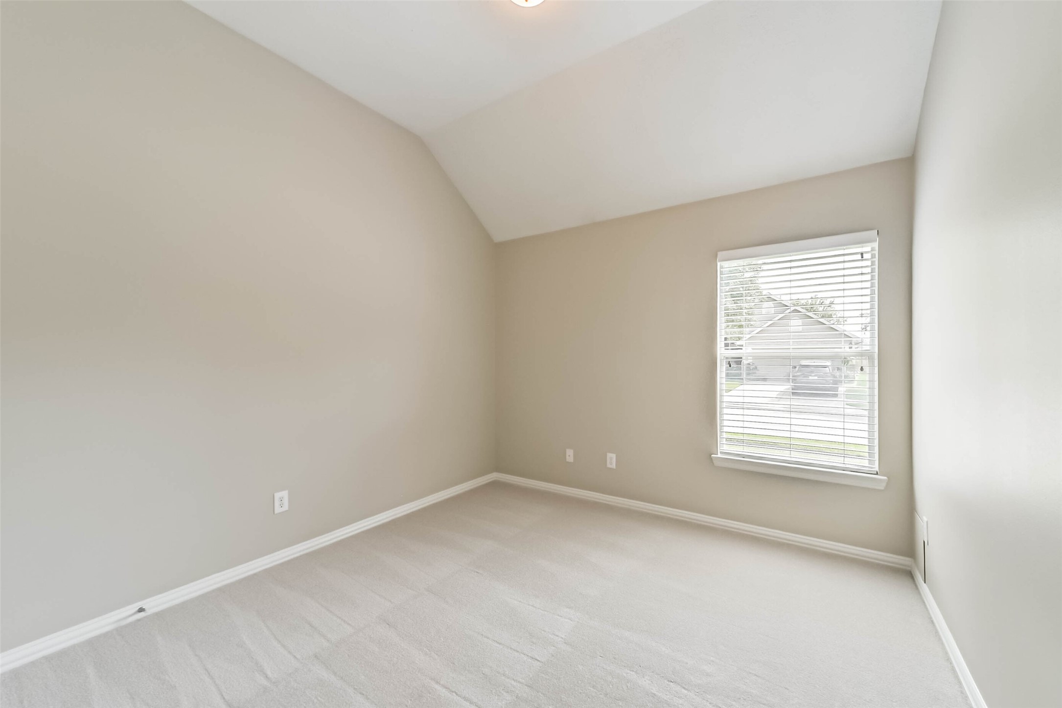 30910 Blue Ridge Park Lane Spring, TX 77386 - Photo 38 of 50 Bright and airy room featuring a vaulted ceiling, soft neutral walls, and a large window that invites natural light, perfect for a cozy retreat or home office.