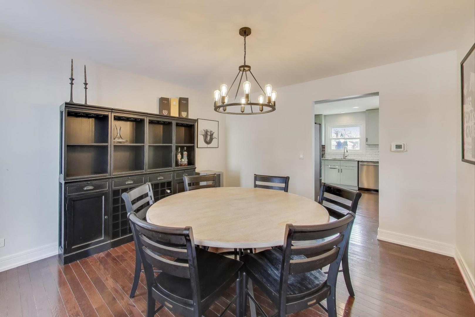 1565 Brittany Lane Hoffman Estates, IL 60192 - Photo 11 of 26 a dining room with a table chairs and kitchen view