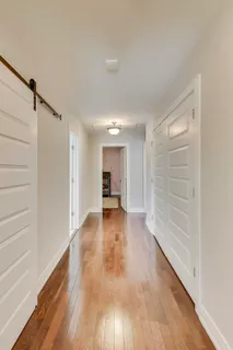 a view of a room with wooden floor closet and windows