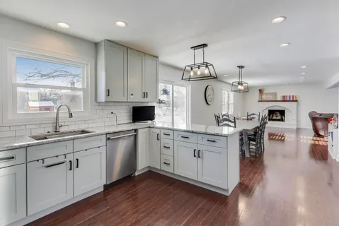 a kitchen with a sink cabinets and wooden floor