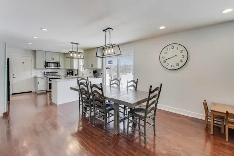 a view of a dining area with furniture window and wooden floor