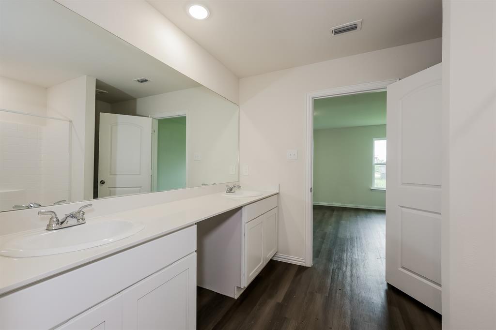 417 Shorty Street Mabank, TX 75147 - Photo 12 of 20 a en suite bathroom with a double vanity sink and a mirror