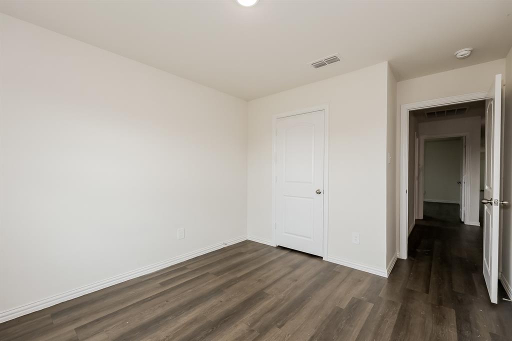 417 Shorty Street Mabank, TX 75147 - Photo 15 of 20 a view of a room with wooden floor and a hallway