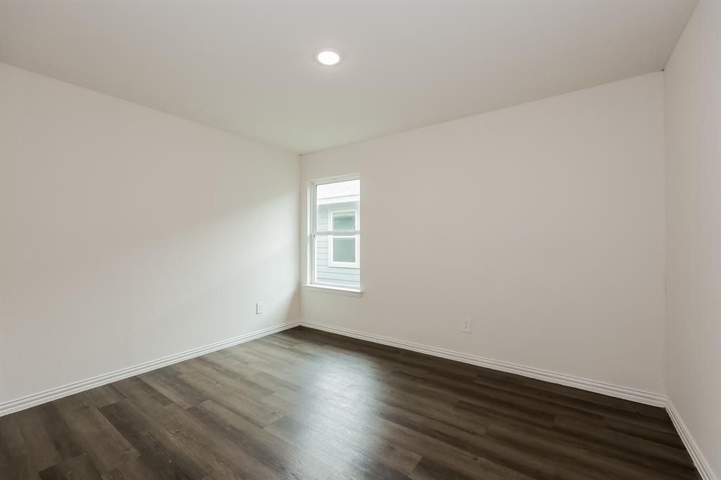 417 Shorty Street Mabank, TX 75147 - Photo 16 of 20 an empty room with wooden floor and windows