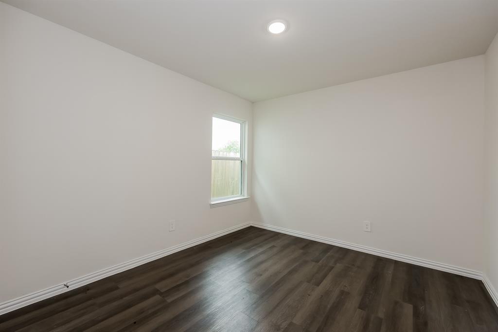 417 Shorty Street Mabank, TX 75147 - Photo 18 of 20 an empty room with wooden floor and windows