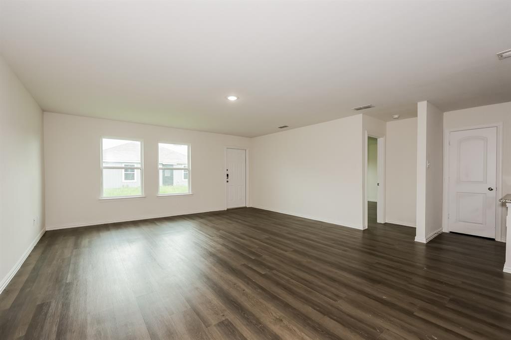 417 Shorty Street Mabank, TX 75147 - Photo 4 of 20 an empty room with wooden floor and windows