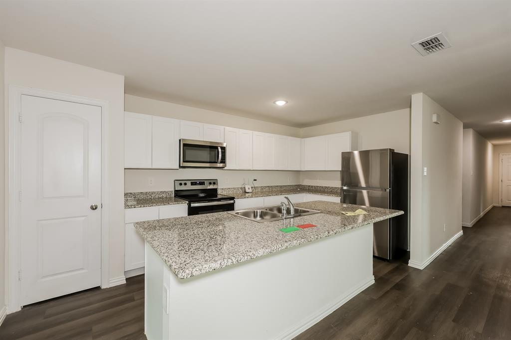 417 Shorty Street Mabank, TX 75147 - Photo 7 of 20 a kitchen with stainless steel appliances granite countertop a sink refrigerator and microwave