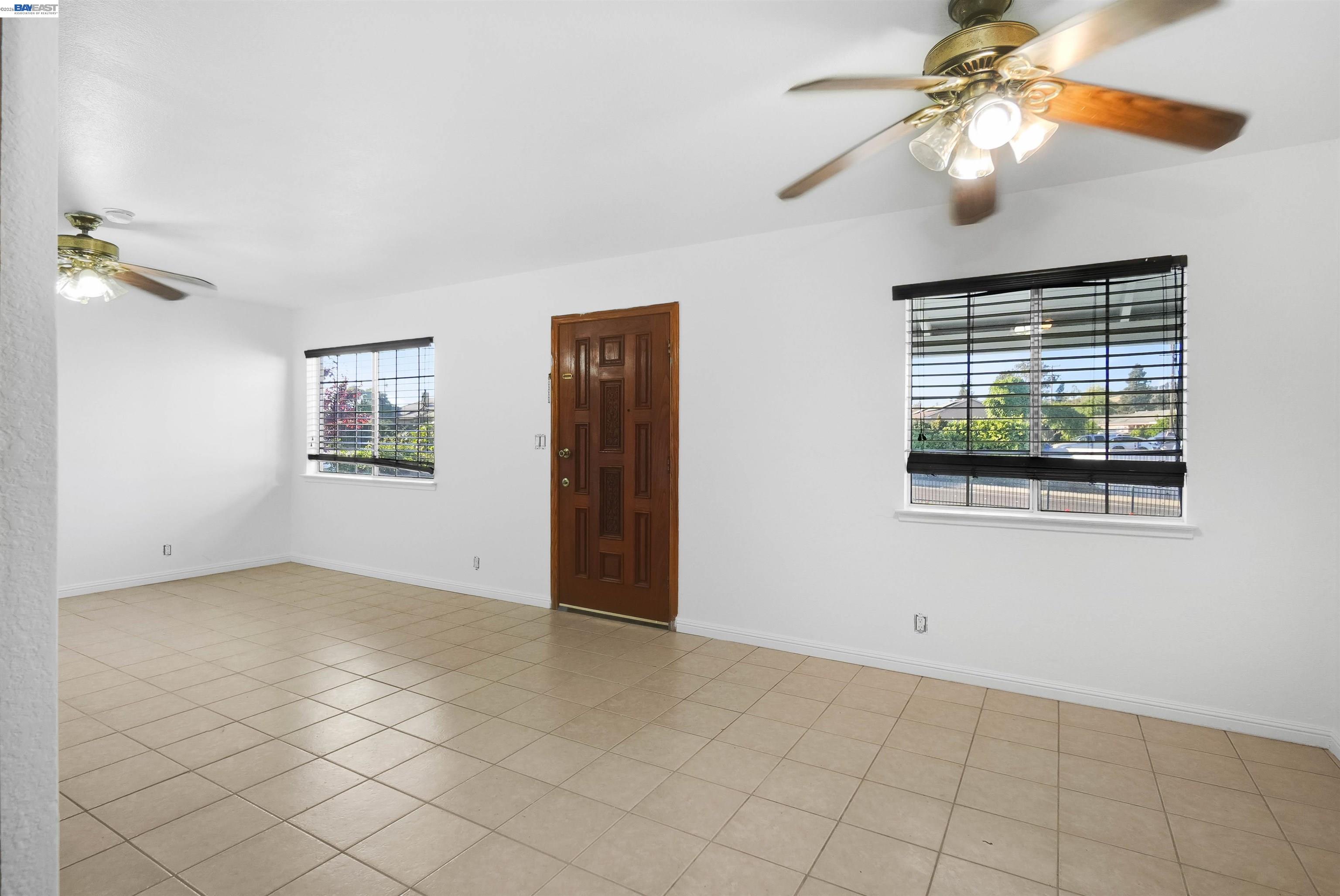 387 Tennyson Road Hayward, CA 94544 - Photo 16 of 48 a view of an empty room with window chandelier fan
