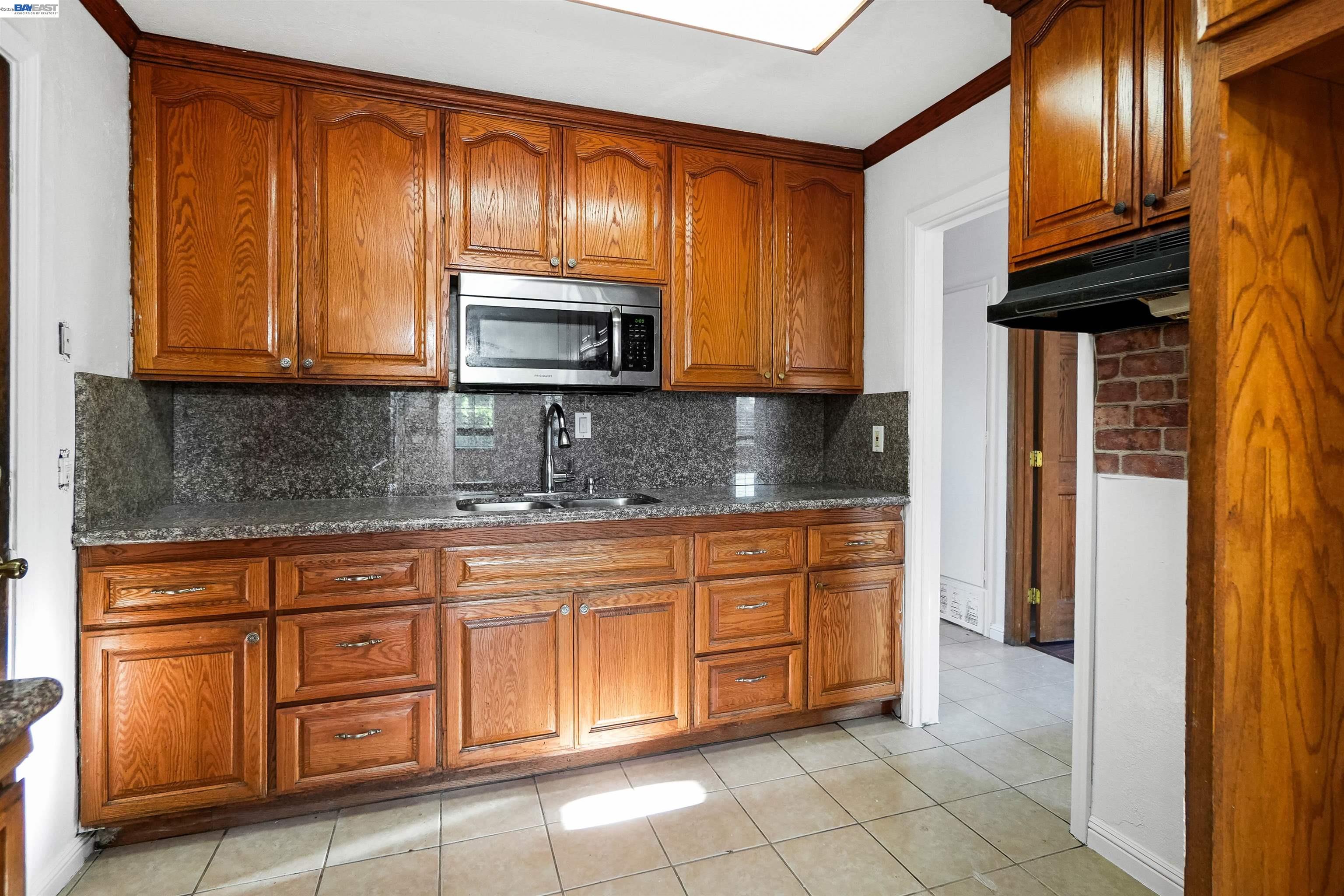 387 Tennyson Road Hayward, CA 94544 - Photo 19 of 48 a kitchen with stainless steel appliances granite countertop a refrigerator a stove a sink and dishwasher