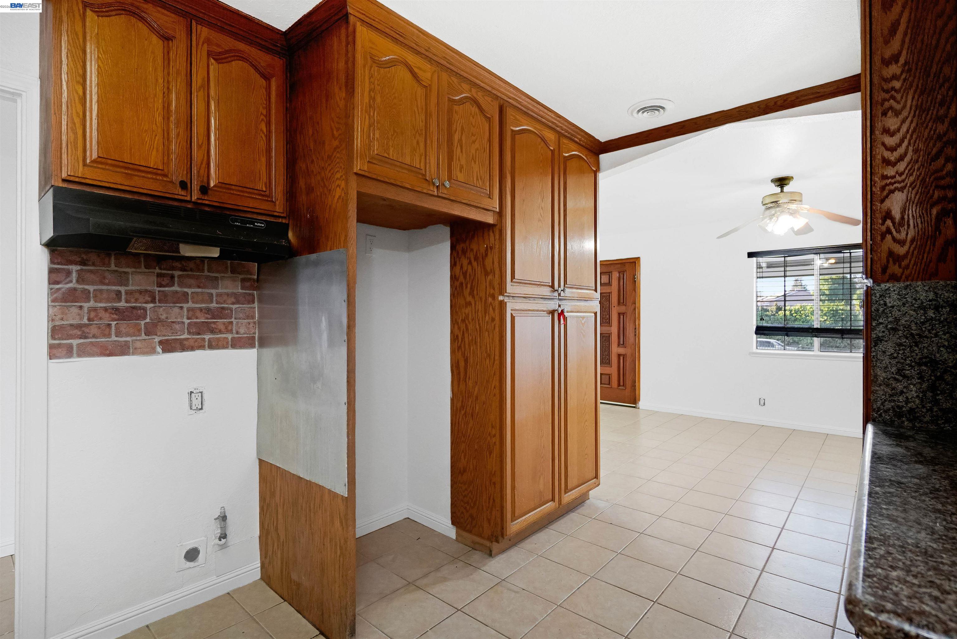 387 Tennyson Road Hayward, CA 94544 - Photo 21 of 48 a view of a refrigerator in kitchen and an empty room