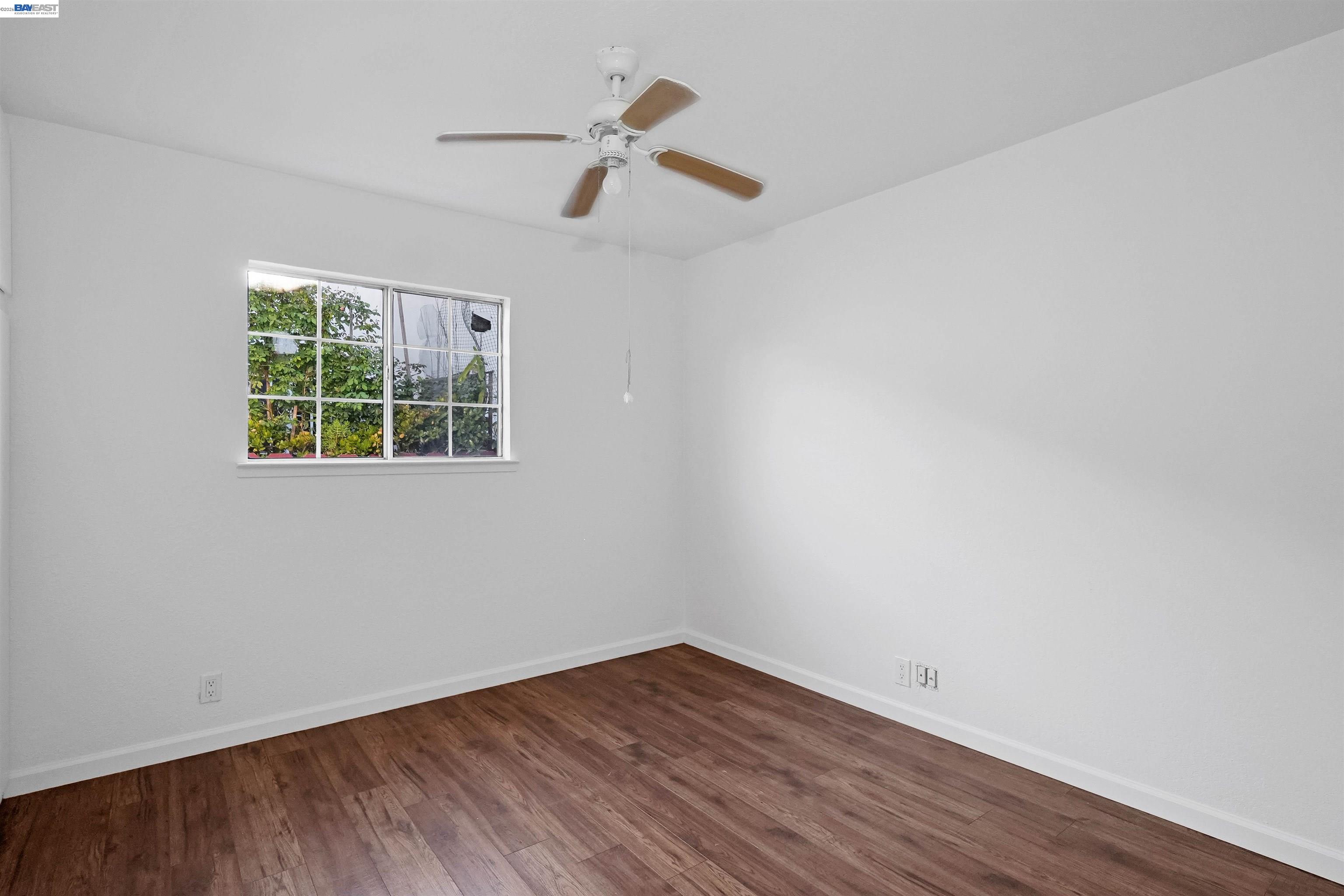 387 Tennyson Road Hayward, CA 94544 - Photo 23 of 48 an empty room with wooden floor and windows