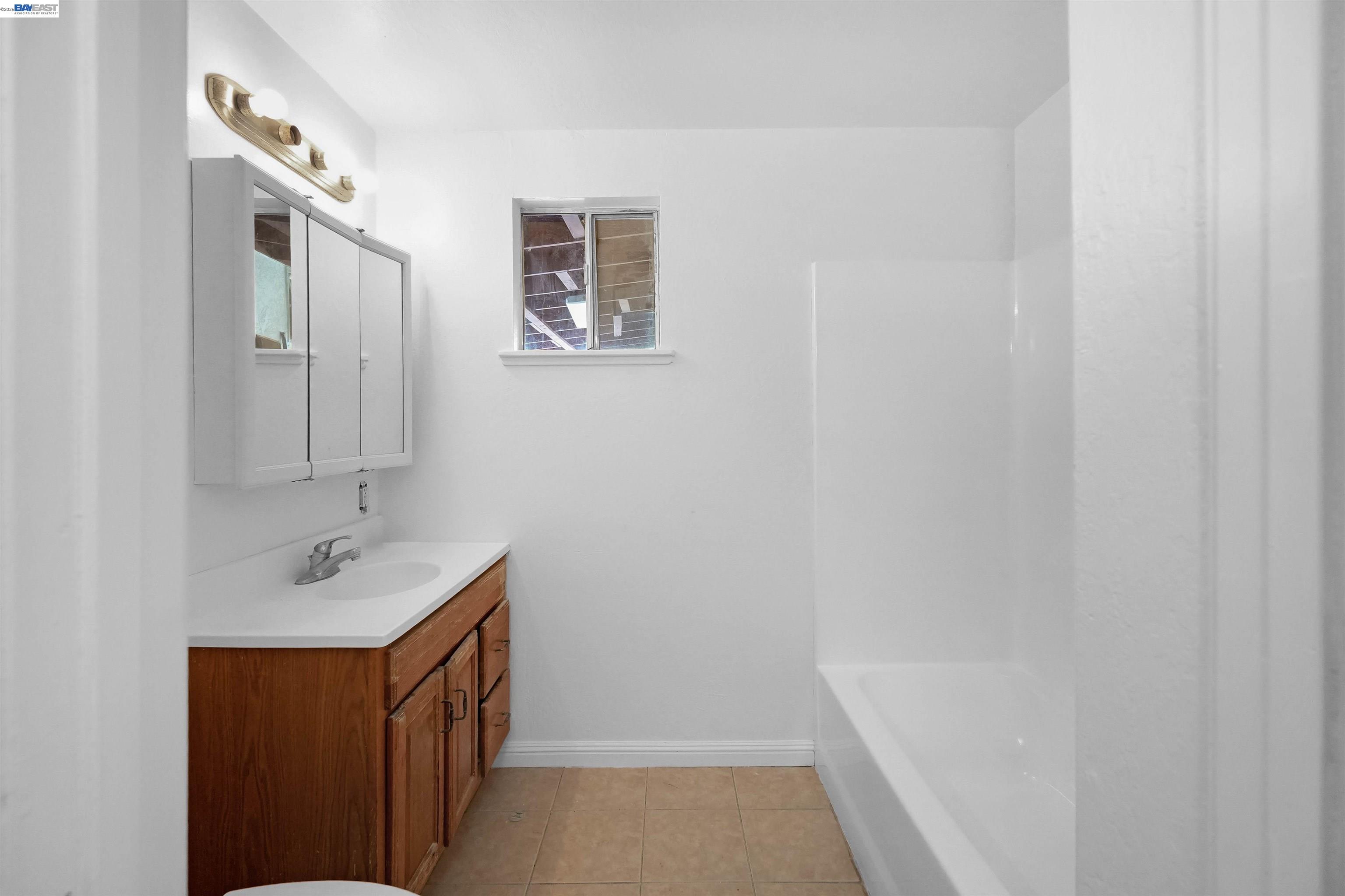 387 Tennyson Road Hayward, CA 94544 - Photo 31 of 48 a bathroom with a tub sink and mirror