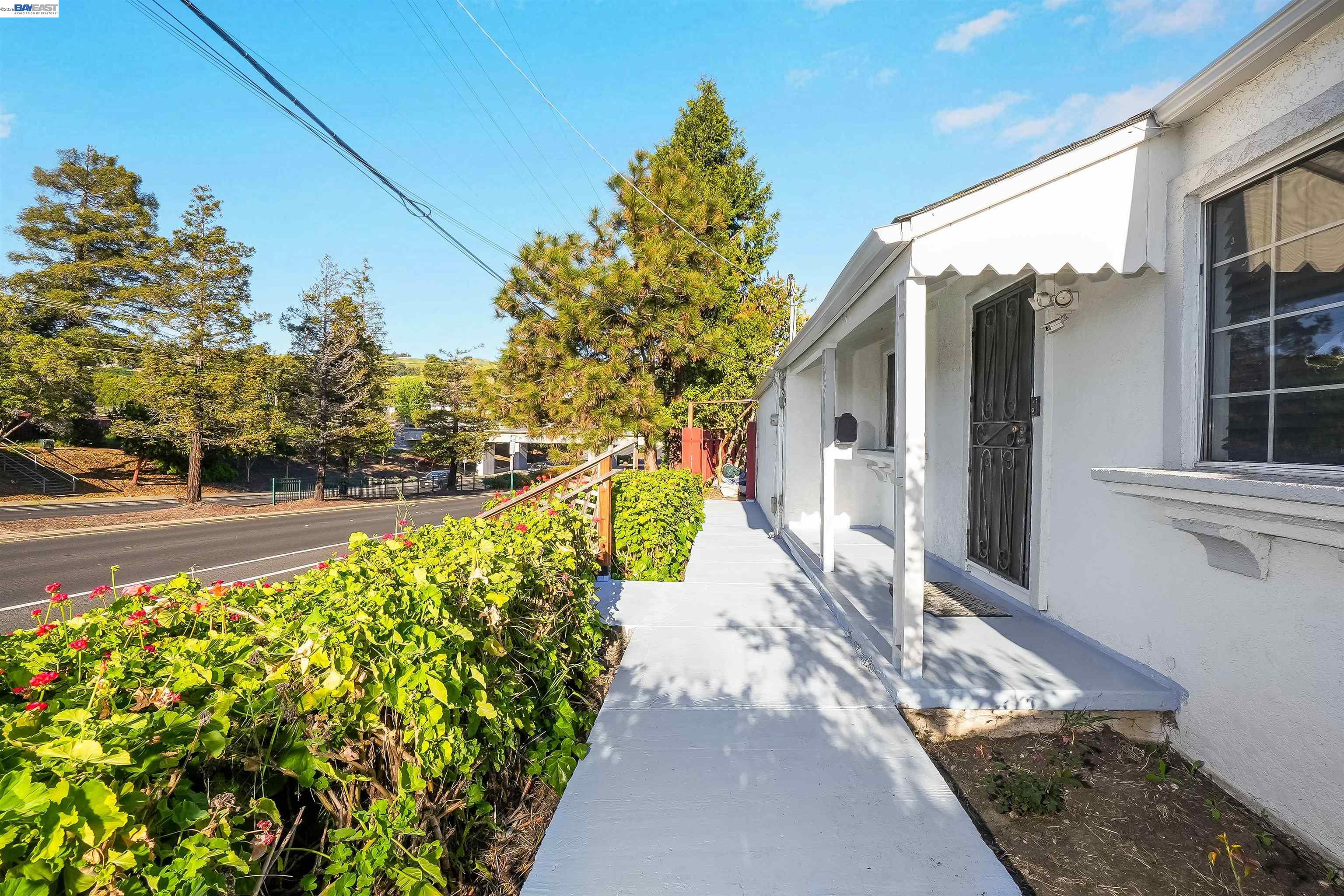 387 Tennyson Road Hayward, CA 94544 - Photo 8 of 48 a view of a pathway of a house with a yard