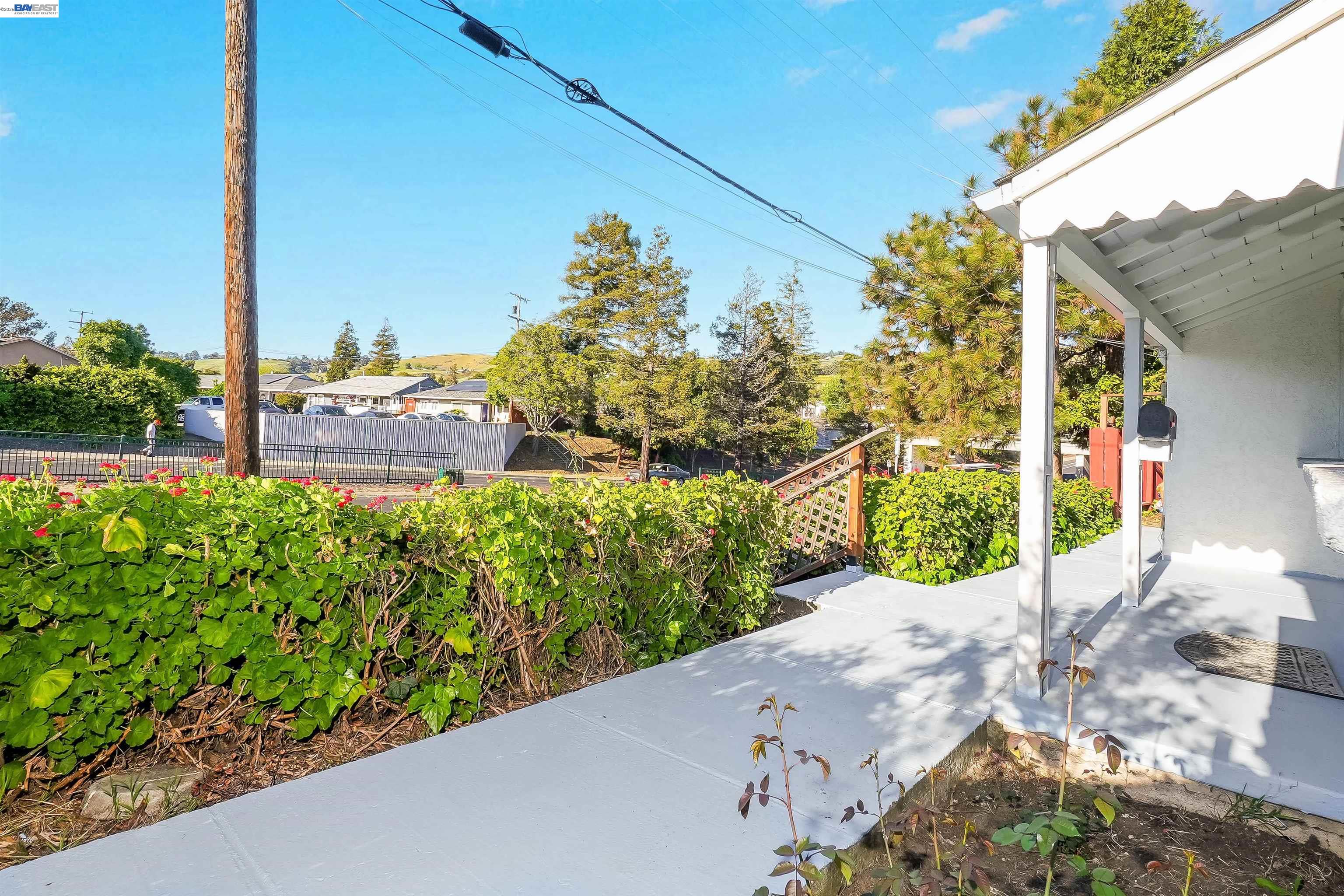 387 Tennyson Road Hayward, CA 94544 - Photo 9 of 48 a view of a street with a bunch of plants and wooden fence