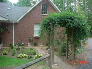 175 River Road Stanfield, NC 28163 - Photo 8 of 8 a view of a yard in front of a house with plants and large trees