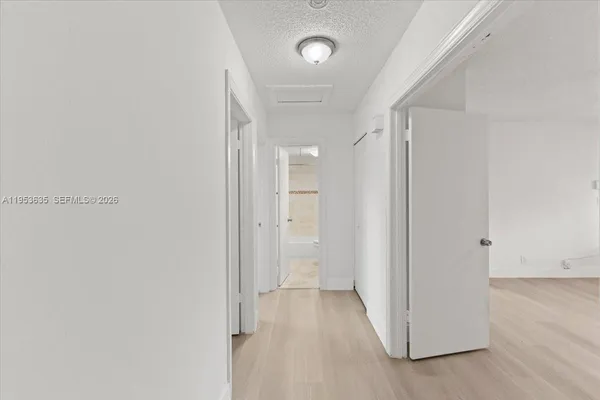 a view of a hallway with wooden floor