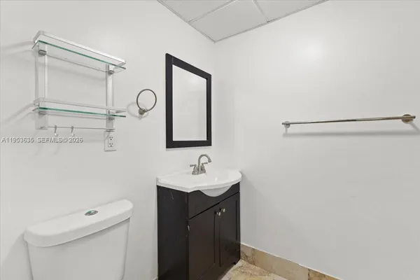 a bathroom with a sink a toilet and a mirror