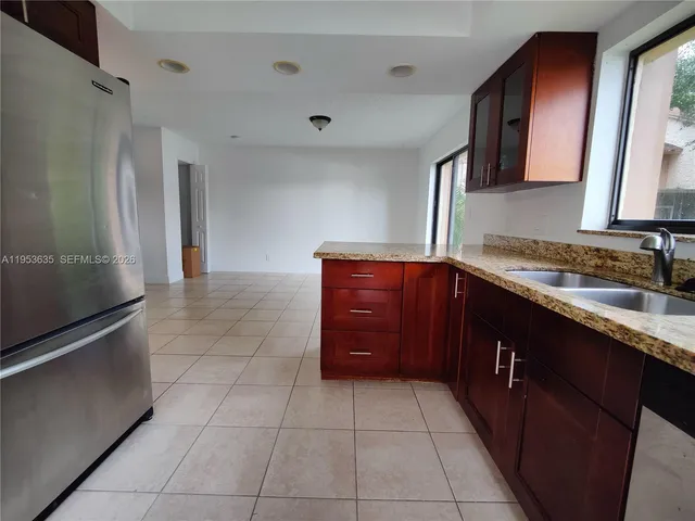 a kitchen with a wooden cabinets and a sink