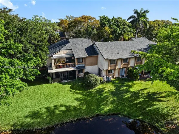 an aerial view of residential house with outdoor space and swimming pool