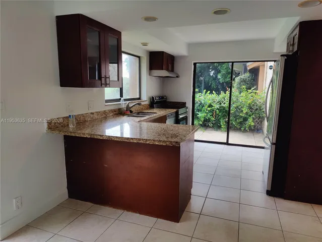 a kitchen with a sink a counter top space and cabinets