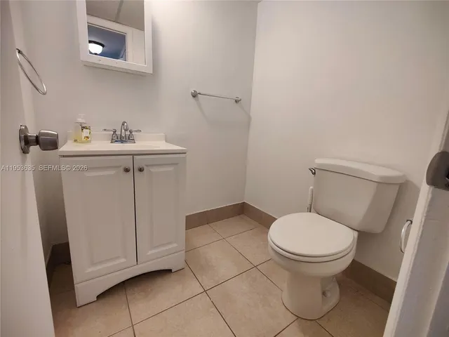a white toilet sitting next to a bathroom sink