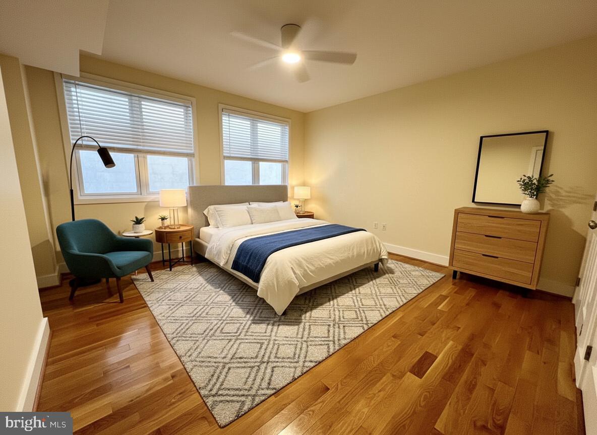 112 Market Street, Unit 4 Philadelphia, PA 19106 - Photo 12 of 15 a spacious bedroom with a bed a couch and window