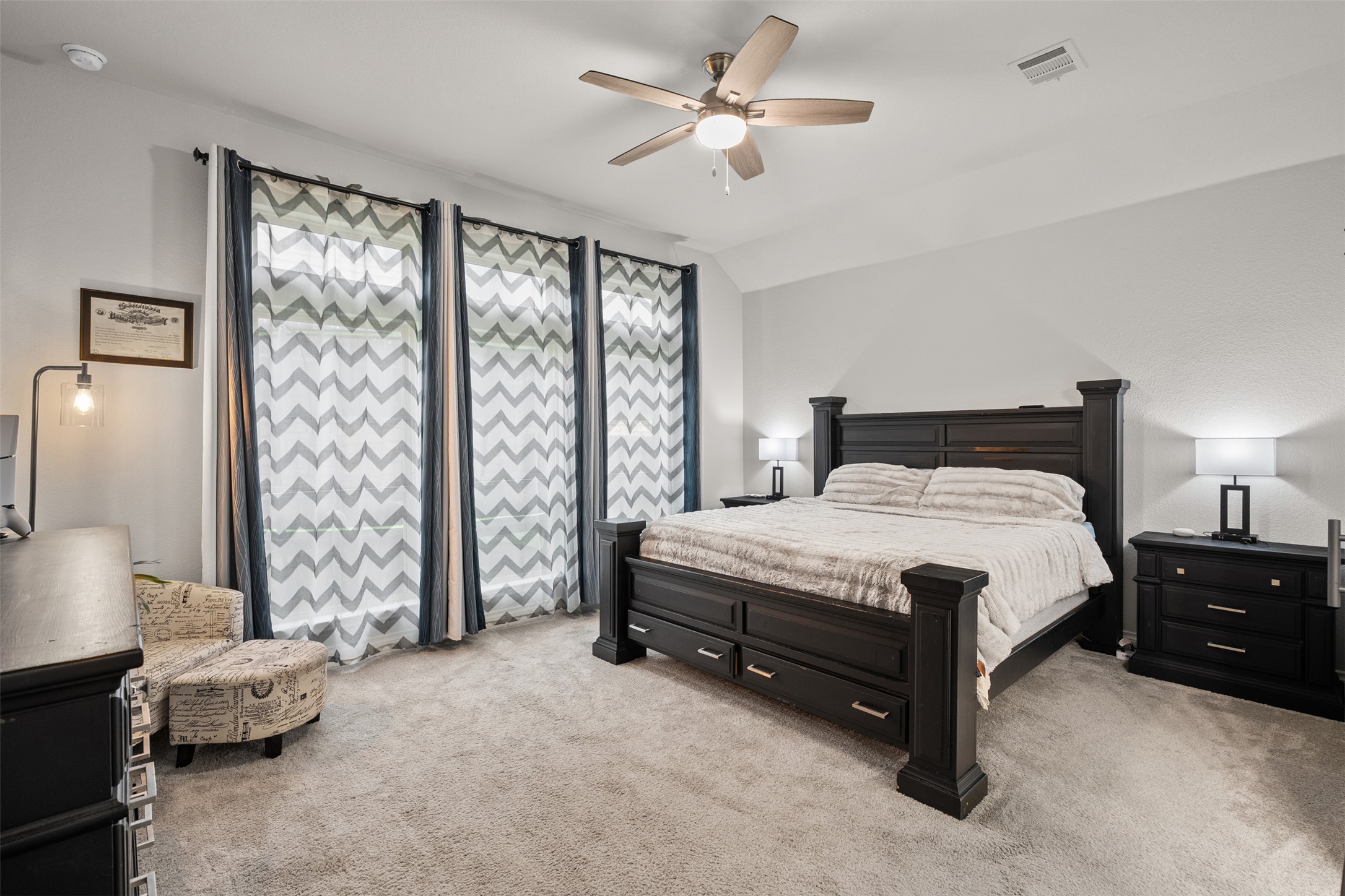 341 Pisa Lane Georgetown, TX 78628 - Photo 19 of 31 a spacious bedroom with a bed and a chandelier