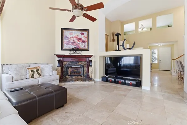 a living room with furniture a fireplace and a flat screen tv